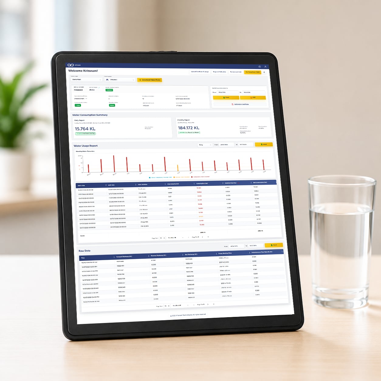 A tablet standing on a desk beside a glass of water; the screen shows a Dhaara Live billing statement with meter-usage rows and a highlighted invoice total.