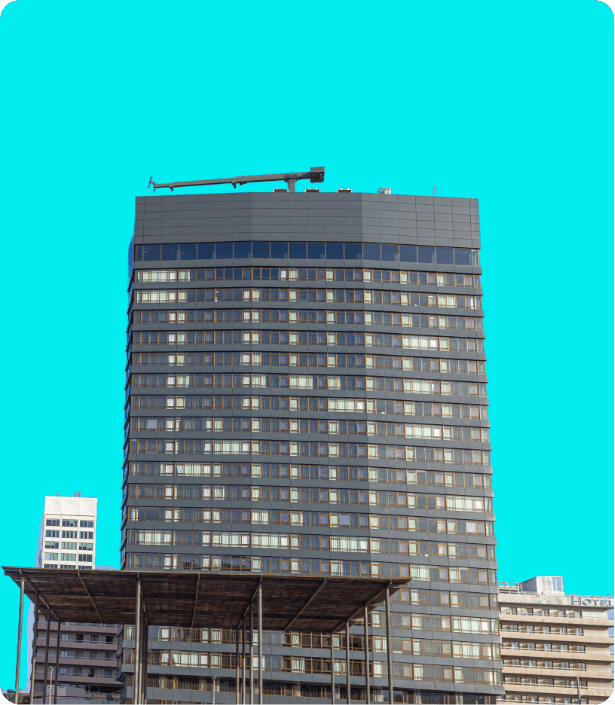 A modern glass-and-steel commercial high-rise. Represents offices, malls, hotels, hospitals, schools and campuses — the Commercial buildings deployment scenario for Dhaara Pulse.