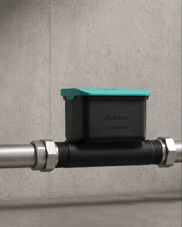 A Dhaara Pulse ultrasonic meter fitted onto the pipe.
