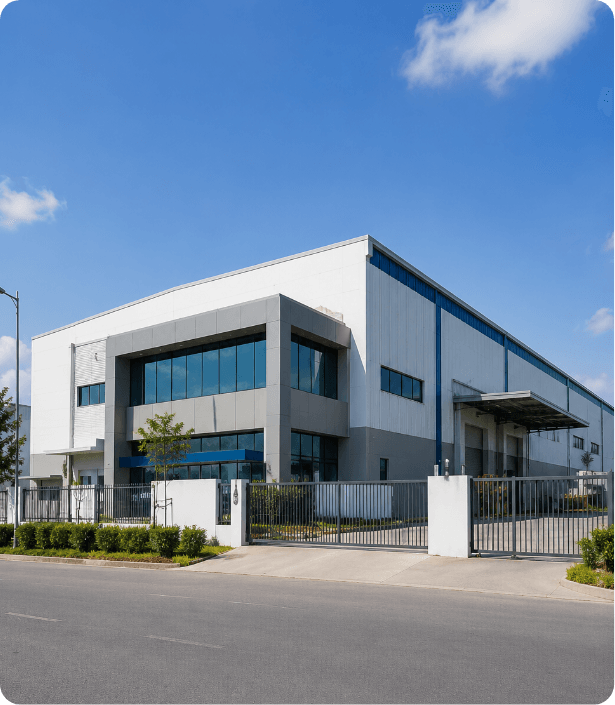 A light-industrial facility with a two-storey office block and a warehouse behind a metal gate. Represents workshops, warehouses, MSMEs and factories — the Small industries deployment scenario for Dhaara Pulse.